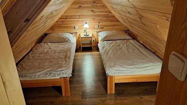 a room with two beds in a attic at Chalupa u Uhříků in Rajnochovice