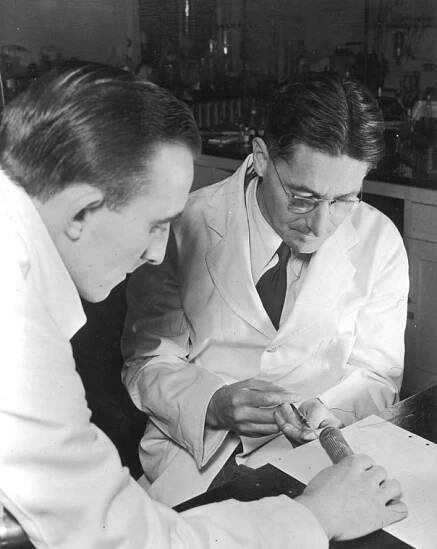 old photo of two men in lab coats