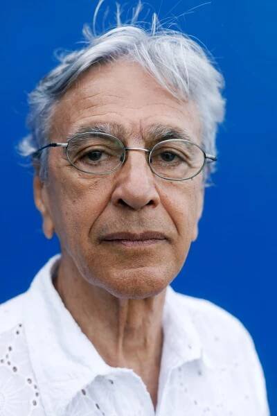 Caetano Veloso against a blue background.