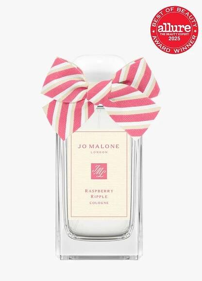 Jo Malone Raspberry Ripple in clear glass bottle with decorative ribbon cap on light gray background with red Allure...