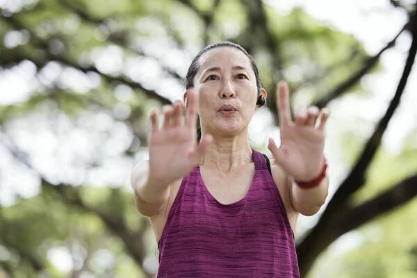 Woman practicing tai chi outside
