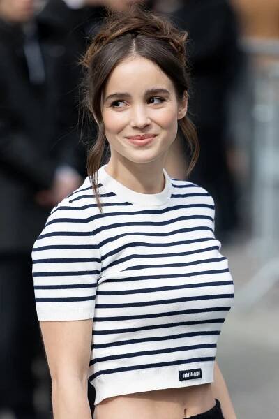 Close-up of Alba in a cropped striped T-shirt