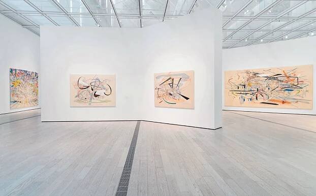 View of “Julie Mehretu,” 2019–20, Los Angeles County Museum of Art. From left: Stadia II, 2004; Babel Unleashed, 2001; Untitled 2, 2001; Retopistics: A Renegade Excavation, 2001.