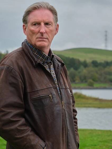 A man stands in a field in Ridley.