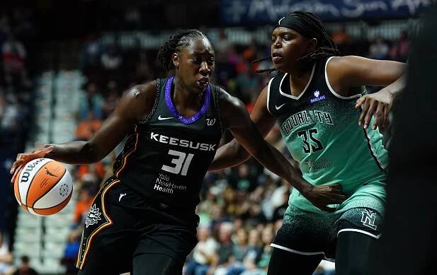 Connecticut Sun center Tina Charles (31) drives the ball against New York Liberty center Jonquel Jones (35) in the first half at Mohegan Sun Arena.