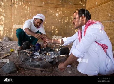 Bedouin host welcomes guests with customary tea in the village of Ras Abu Gallum, north of the Sinai resort of Dahab in Egypt Stock Photo