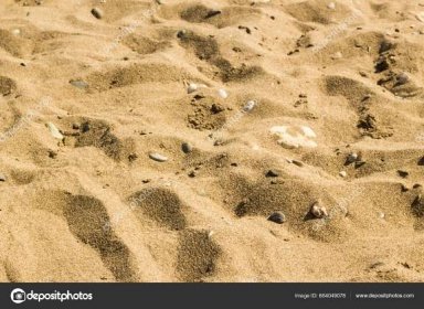 Download - Beach sand with stony and shoe prints,above view — Stock Image