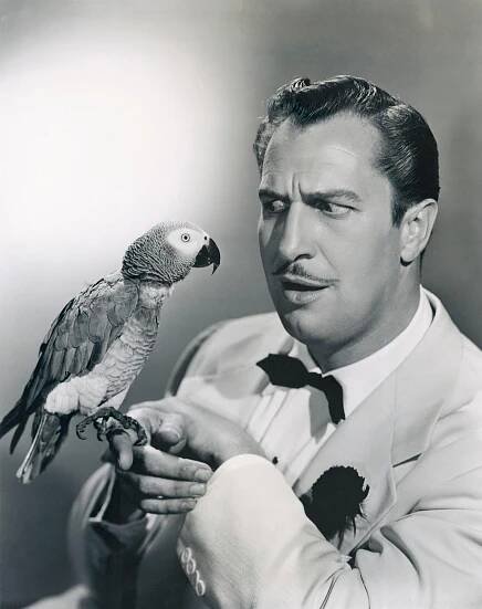 Vincent Price Holding A Parrot.