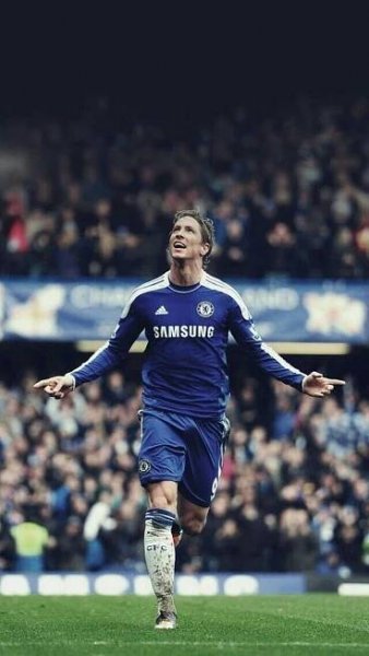 a soccer player is running on the field with his arms out and eyes open in celebration