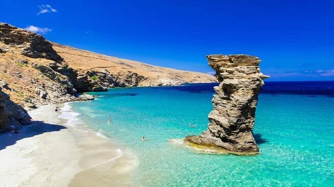 Pidima Tis Grias: Greece is full of must-visit spots. This spectacular beach is located on Andros, a luscious island near Athens. According to legend, Pidima Tis Grias is named for an old woman who betrayed a nearby town to Saracen pirates, jumped off a cliff to her death and was turned into a vertical, isolated rock.