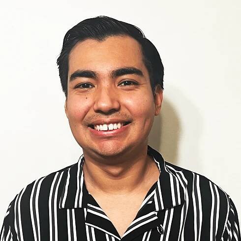 Headshot photo of Luis Angel Martinez. Luis has short brown hair and is smiling. He wears a black and white striped dress shirt.