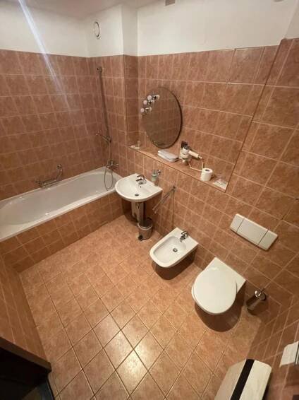 a bathroom with a sink and a toilet and a tub at Hotel Bravo in Česká Třebová