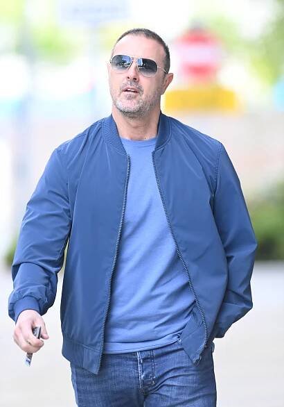 Paddy McGuinness walking outdoors.