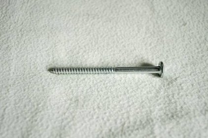 a screw is laying on a white sheet