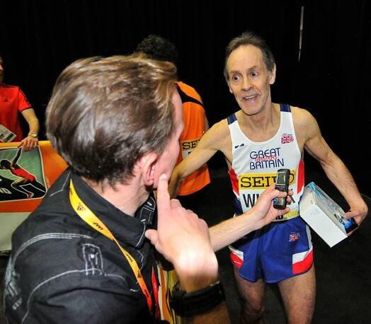 David Wilcock describes his race to an interviewer in the mixed zone.