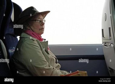 A n older lady travelling on a train Stock Photo - Alamy