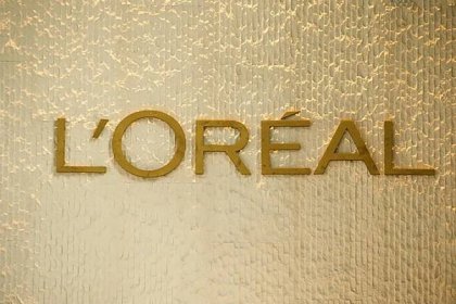Gold L'oreal logo on a gold background