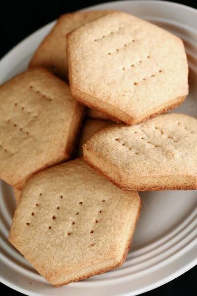 A plate of hexagonal gluten free shortbread cookies.