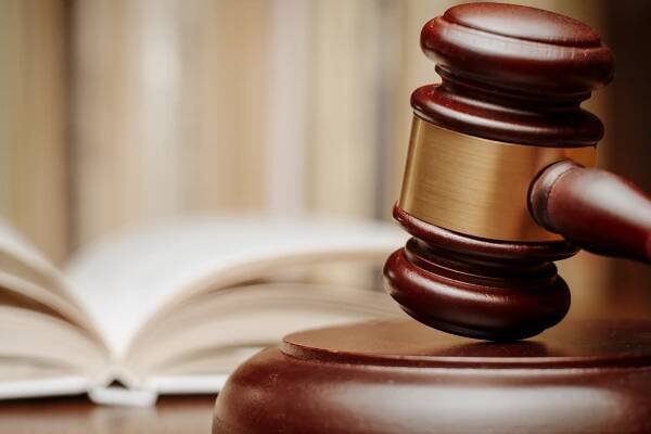 A gavel is seen in a courtroom.