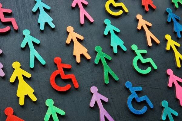 Nálepka Diversity and inclusion concept. Colorful figurines on the dark surface.