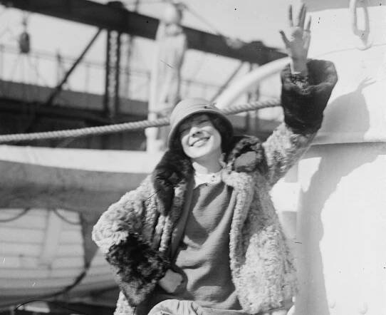 Adele Astaire wearing coat and hat ,smiling outside - 1923