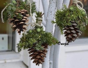 three pine cones hanging from a tree with twine needles and green balls attached to them