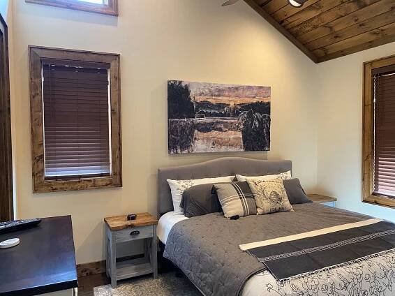 Art in a home in Banner Elk, NC at Eagles Nest. This photo shows interior design in a bedroom with a bear painting hanging over the bed.