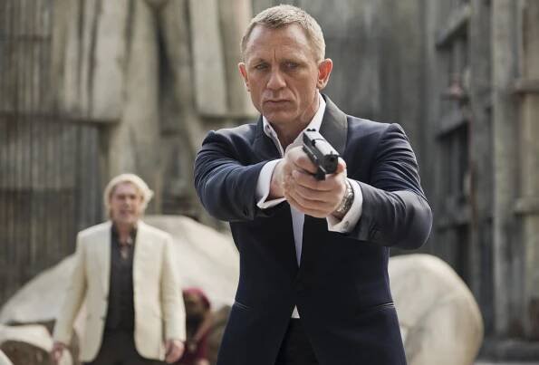Daniel Craig aiming a gun in a scene still from Skyfall.