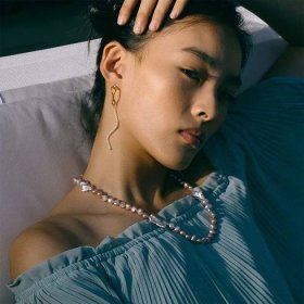 Model wearing pearl earrings and pearl necklace from Ming Yu Wang