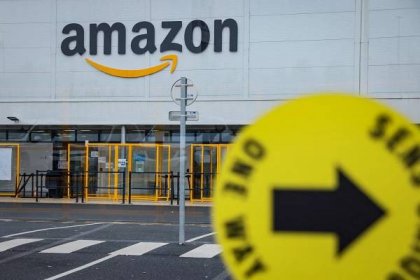 (FILES) A picture shows the Amazon logo on the frontage of an Amazon's centre in Bretigny-sur-Orge, on December 14, 2021. France's data protection agency said on January  23, 2024, that it had fined Amazon's French warehouses unit 32 million euros (34.9 million USD) for an "excessively intrusive" surveillance system to keep track of staff performance. Amazon France Logistique monitored the work of employees in particular through data from scanners used by the staff to process packages, according to the agency, known by its initials CNIL. (Photo by Thomas SAMSON / AFP) (Photo by THOMAS SAMSON/AFP via Getty Images)

