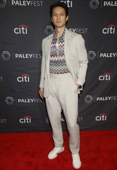 Harry Shum Jr. stepped out in a light beige suit paired with a colorful zigzag-patterned shirt and crisp white sneakers at PaleyFest, blending casual flair with retro sophistication