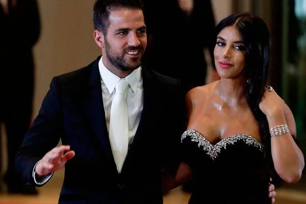 Chelsea's Cesc Fabregas, left, and Daniella Semaan pose for a photo before the start of the wedding of Lionel Messi and Antonella Roccuzzo, in Rosario, Argentina, Friday, June 30, 2017. Some 260 guests, including teammates and former teammates of the Barcelona soccer star, are attending the highly anticipated ceremony. (AP Photo/Victor R. Caivano)