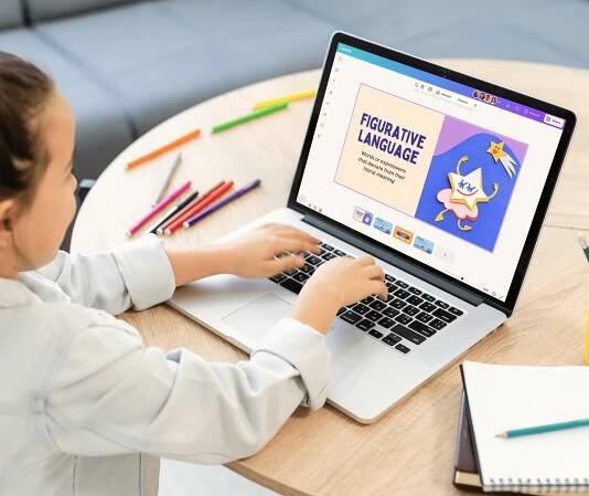 Young student working using Canva on their desktop computer