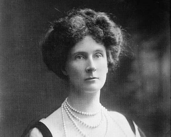 Duchess Of Devonshire wearing black dress is looking at side.