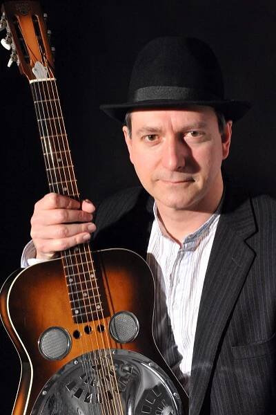 Michael holding resonator guitar