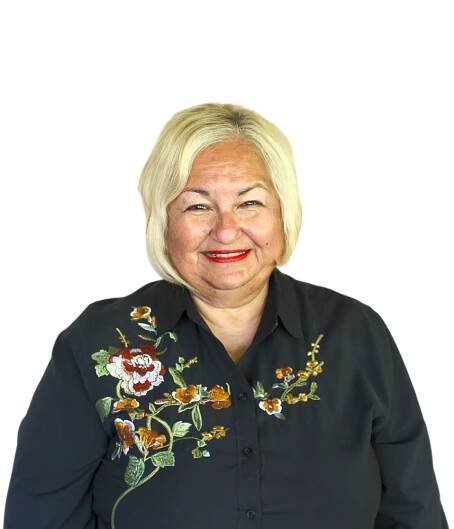 A woman wearing a black shirt with flowers on it