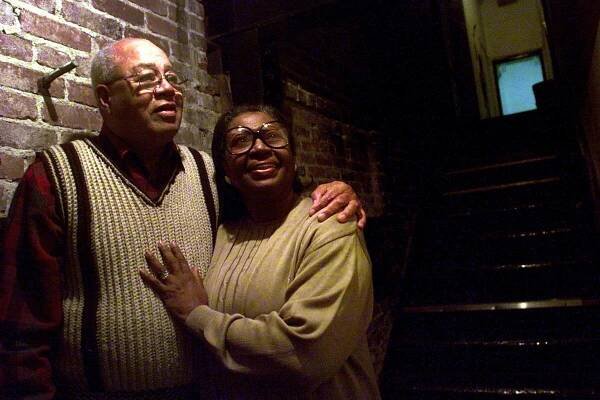 Lynn Hamilton stands close to Frank Jenkins with her hand on his chest and his arm around her shoulders