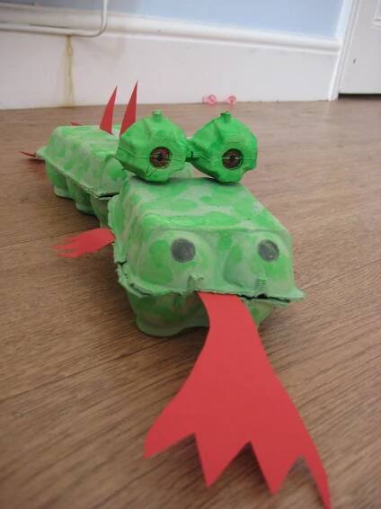 the paper mache is shaped like a green dragon