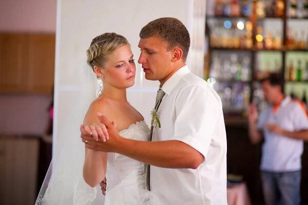 A bride and groom dancing awkwardly on their wedding day.