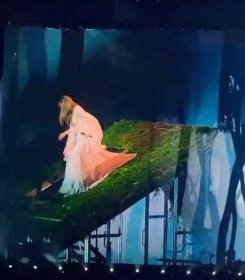 taylor swift walking down stairs of a roof (concert set)