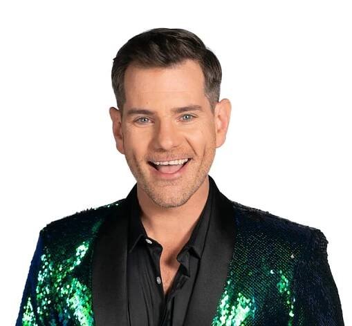 Man wearing a sparkly green jacket over a black shirt.