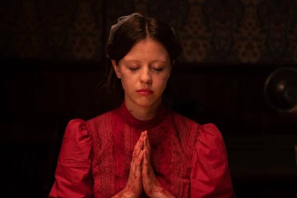 Mia Goth holds her hands together in a prayer position in A24's Pearl.