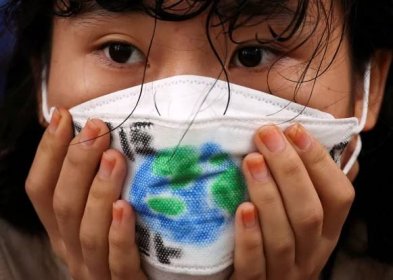 A girl wears a face mask with a drawing of the earth as she takes part in a global climate protest near the presidential office in Seoul, South Korea, September 23, 2022. REUTERS/Kim Hong-Ji
