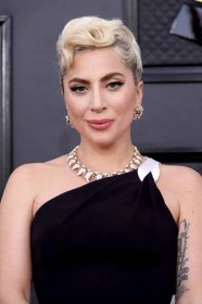 Lady Gaga with pinned up curls, a fresh face, and white liner