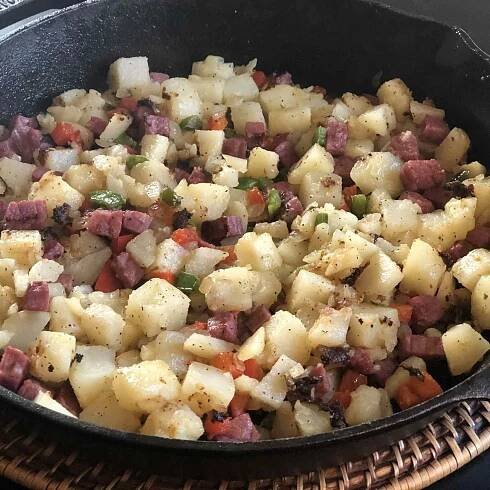 potato hash and corned beef in a skillet