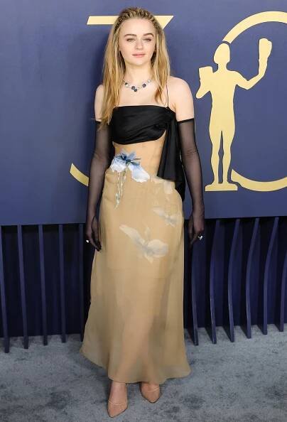Joey King attends the 2024 Screen Actors Guild Awards in a nude and black Givenchy gown with blue iris floral prints on February 24, 2024