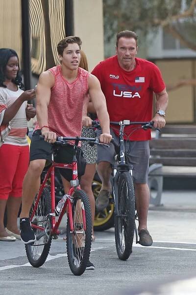 Joe Baena and Arnold Schwarzenegger on bicycles
