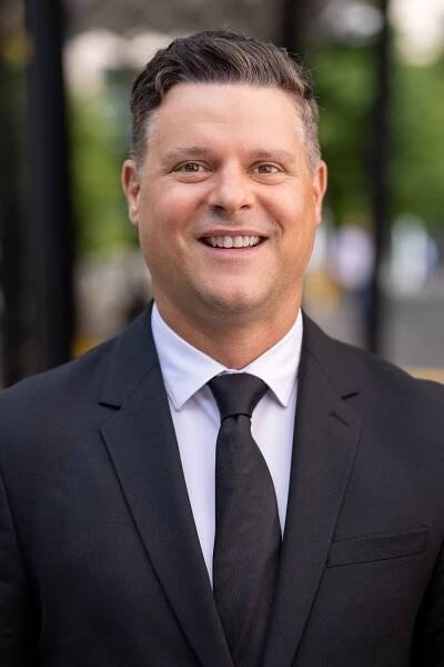 smiling man in black suit 