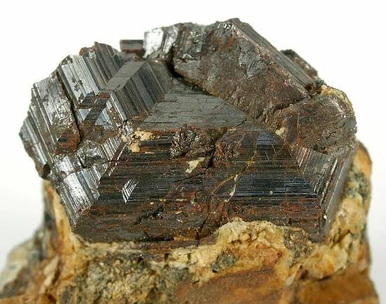A well-sized matrix specimen hosting at its peak a sharply twinned, very geometric, rutile crystal