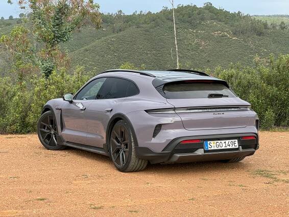 Rear 3/4 view of a lavender 2025 Porsche Taycan Turbo S Cross Turismo